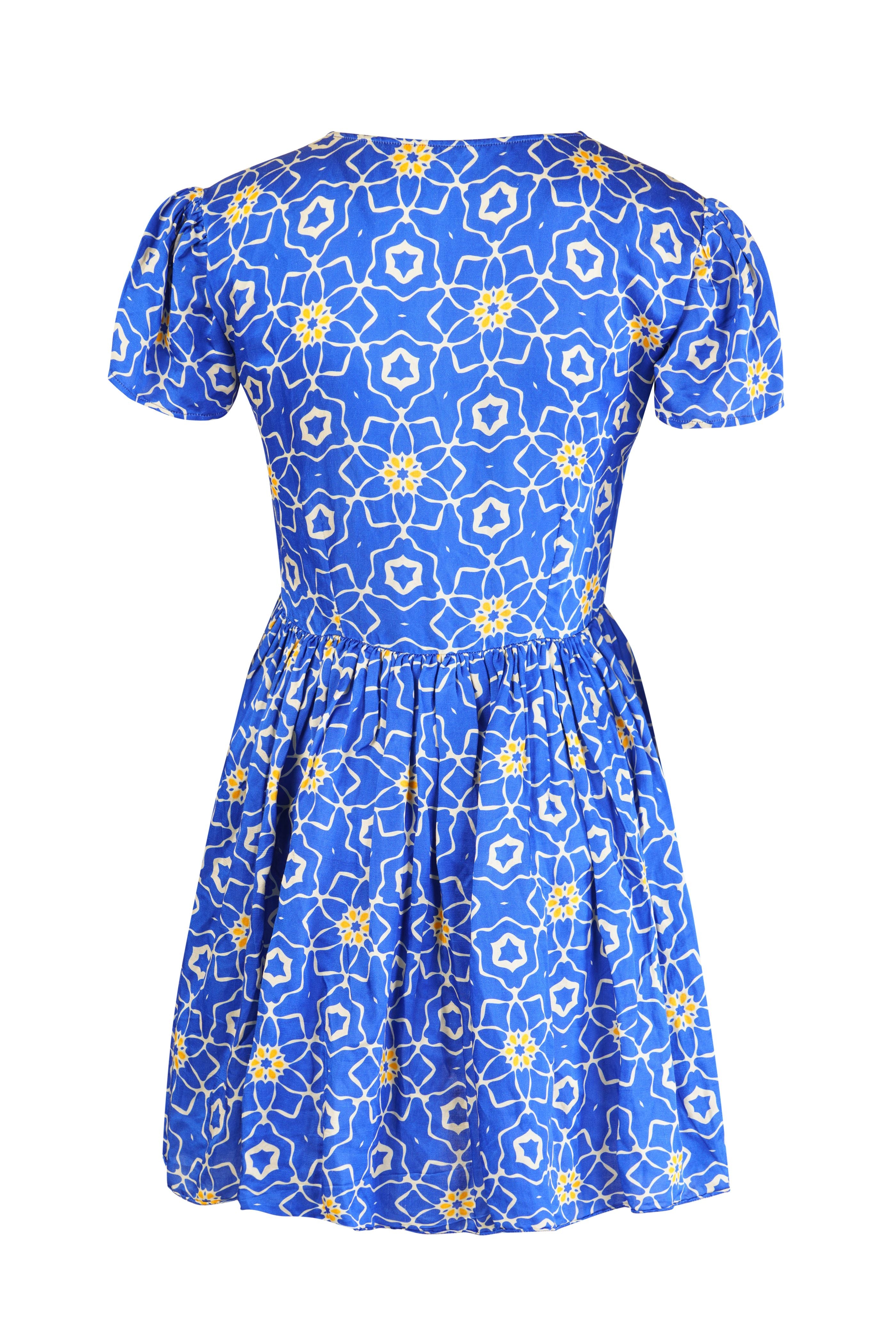 Designer Sorrento midi length beach dress for women with a V-neckline, front knot, short puff sleeves and a gathered skirt. Stylish beachwear and resort wear for summers.