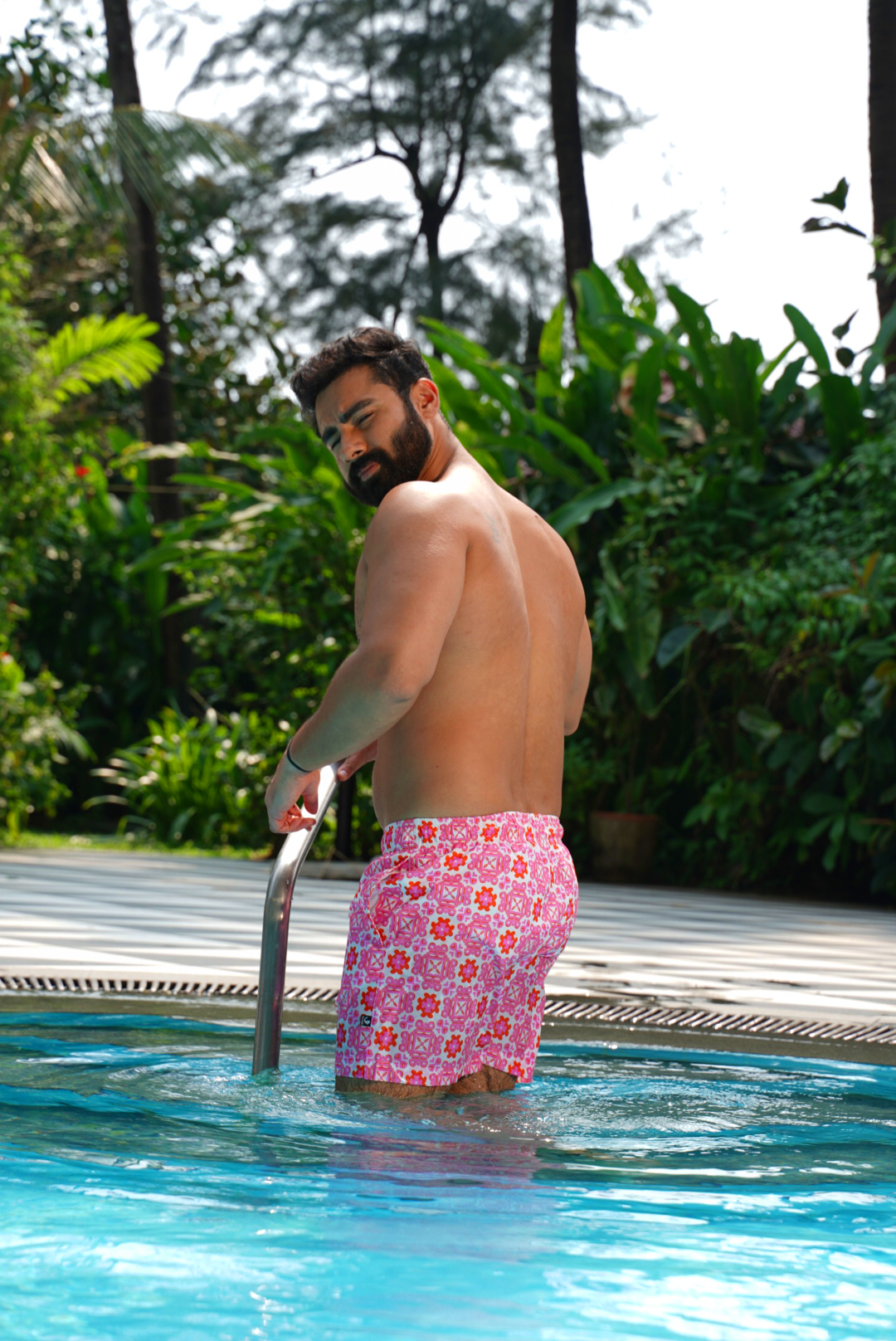 Designer Positano swim shorts for men in quick-dry fabric with geometric floral print, elastic waistband, drawstring and matching family set. Customizable and in plus sizes. Comfortable and lightweight swimwear for summers or holiday outings.