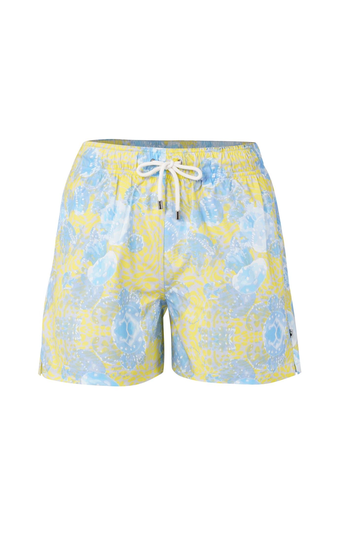 Model wearing Bergamo shorts for men in blue tropical print, styled as designer beachwear and stylish summer wear for men.
