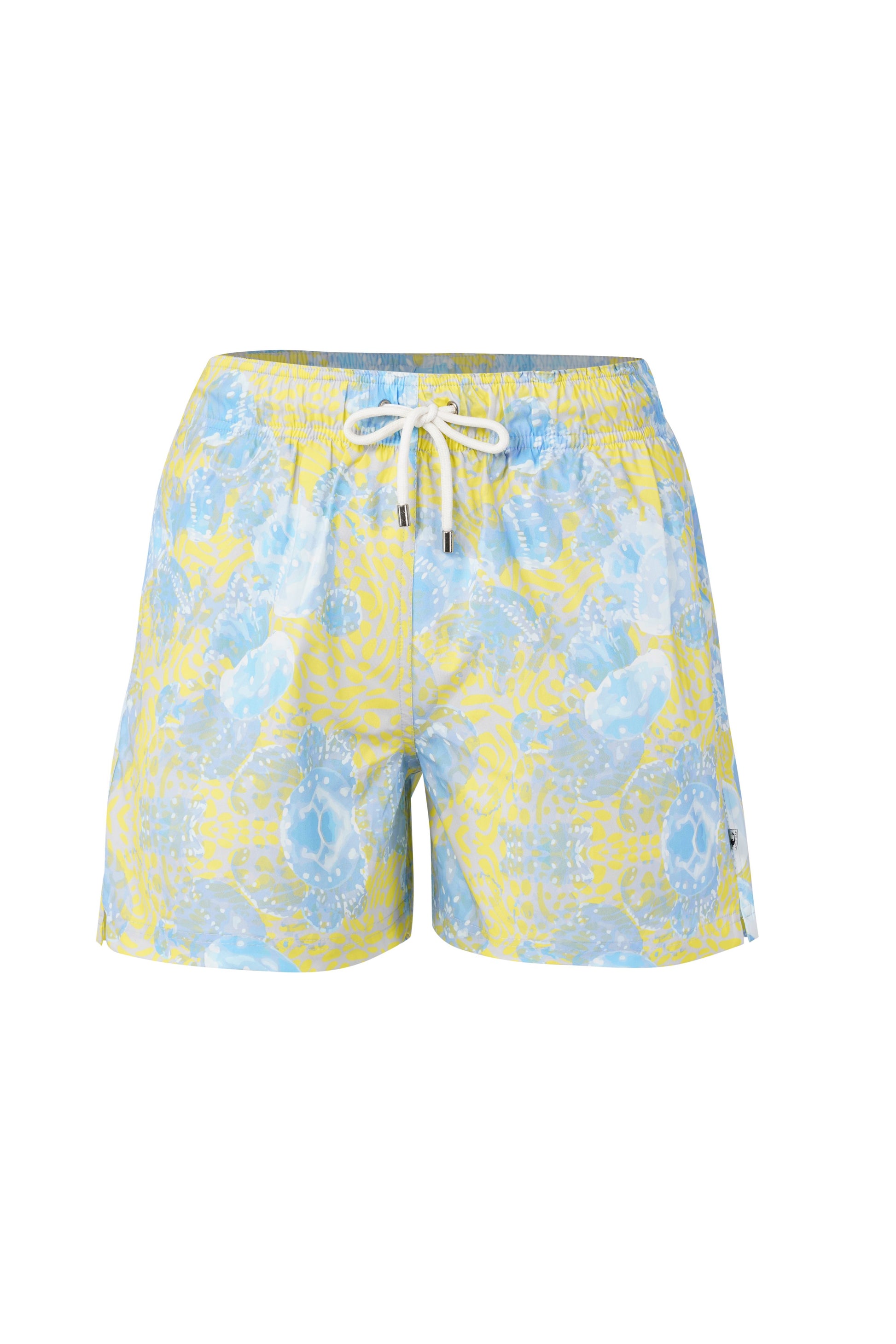 Model wearing Bergamo shorts for men in blue tropical print, styled as designer beachwear and stylish summer wear for men.