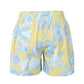 Model wearing Begarmo shorts for men in blue tropical print, styled as designer beachwear and stylish summer wear for men.
