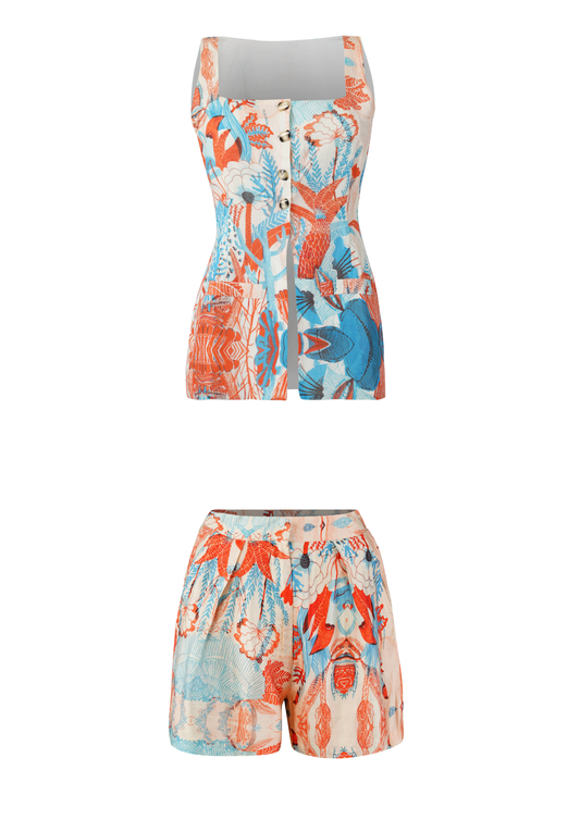 Women’s tropical printed coord set with strapped button-front top and high-waist shorts in coral and blue.