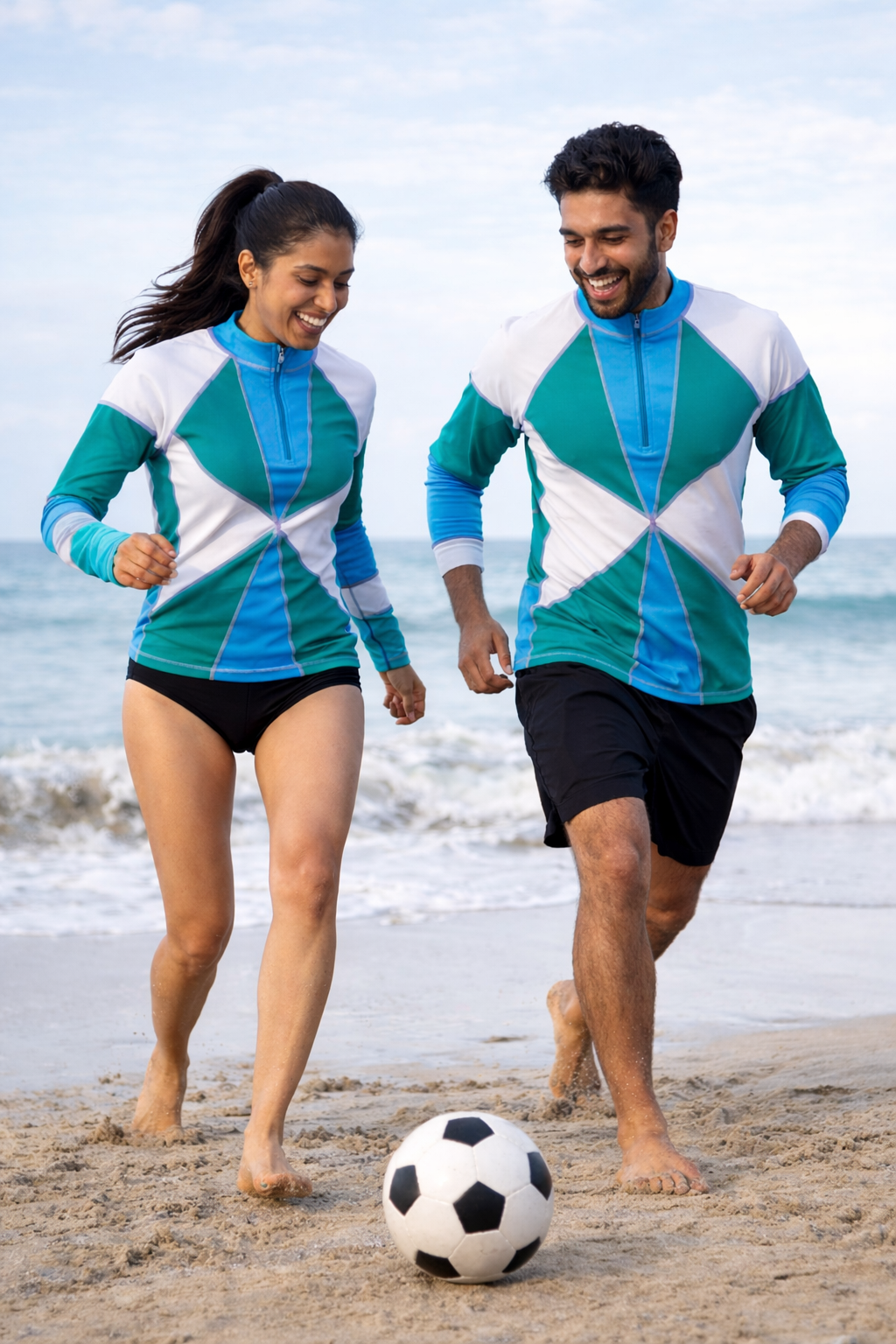 Designer, unisex Reef Rider rash guard made from quick-dry sustainable fabric in blue and green geometric design, long sleeves, front zip, SPF 50+ UV protection and plus sizes. Customizable and sustainable swimwear for your water adventures.