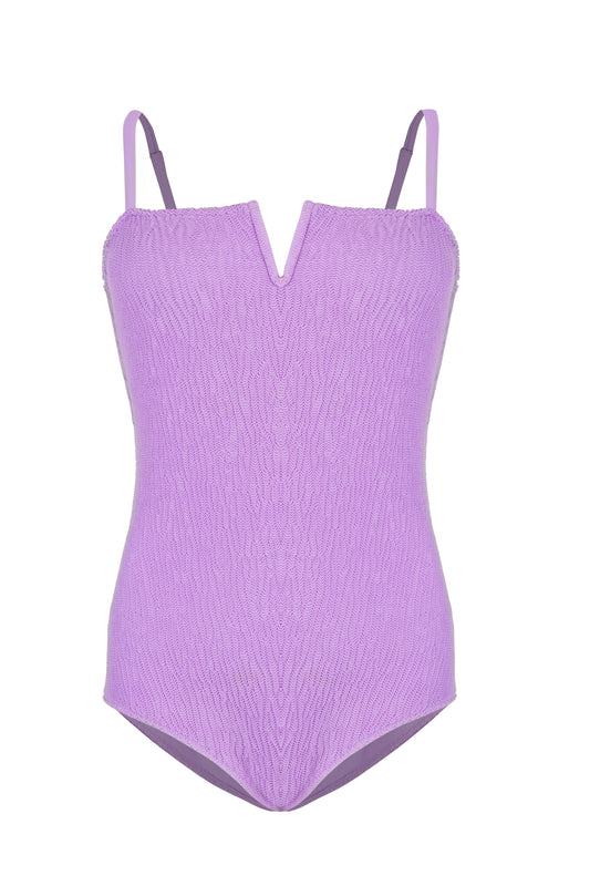 Sicily monokini for women, a one piece swimsuit in purple and pink textured fabric with an elegant V neckline and adjustable straps.