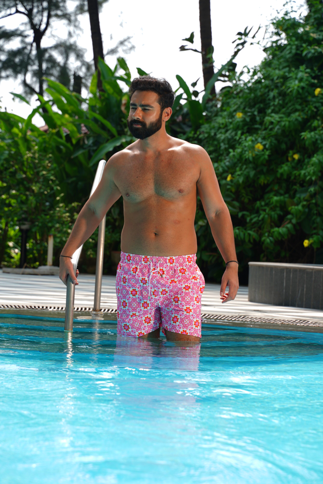 Designer Positano swim shorts for men in quick-dry fabric with geometric floral print, elastic waistband, drawstring and matching family set. Customizable and in plus sizes. Comfortable and lightweight swimwear for summers or holiday outings.